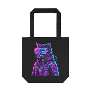 May include: Black tote bag with a neon cyberpunk cat design. The cat is depicted wearing futuristic goggles and a jacket. The design includes the words "Cyberpunk," "Neon," and "8Bit" in vibrant pink, blue, and purple.