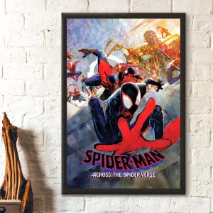 May include: A framed poster featuring a dynamic illustration of multiple Spider-Man characters in action poses. The central figure is in a black and red suit with a large red hand reaching forward. The text reads SPIDER-MAN ACROSS THE SPIDER-VERSE.