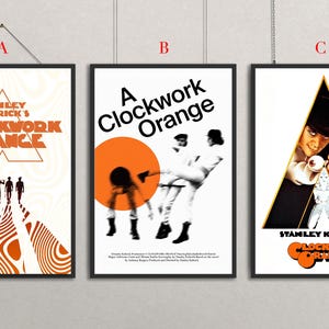 May include: Three framed movie posters for "A Clockwork Orange." The posters feature the film's title and imagery in orange and black. The posters are displayed against a neutral background.