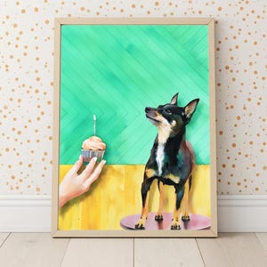 May include: A framed print featuring a black and tan dog gazing up at a cupcake with a lit candle. The background is divided into green and yellow sections. The dog stands on a pink circle.