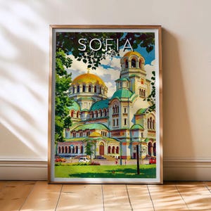 May include: Framed art print featuring the Alexander Nevsky Cathedral in Sofia, Bulgaria. The artwork showcases the cathedral with gold domes, green roofs, and a detailed architectural design. The word "SOFIA" is printed at the top.
