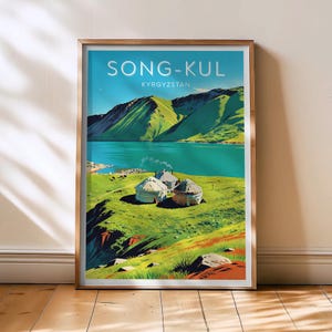 May include: A framed travel poster featuring a scenic view of Song-Kul, Kyrgyzstan. The artwork depicts a turquoise lake, green mountains, and traditional yurts on a grassy plain. The poster has a gold frame and the text "SONG-KUL" and "KYRGYZSTAN".
