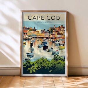 Puede incluir: Impresión artística enmarcada que presenta una colorida ilustración de Cape Cod, Massachusetts. La obra representa una escena portuaria con barcos, edificios y el texto "CAPE COD MASSACHUSETTS" en un estilo de cartel de viaje vintage. La impresión está en un marco de madera.