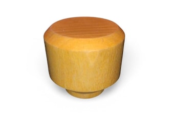 May include: A wooden bottle stopper with a light brown top and a light yellow body. The stopper has a cylindrical shape with a slightly tapered body and a small base. The top is a darker shade of brown than the body.