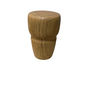 May include: A wooden furniture leg with a light brown finish. The leg has a cylindrical top and a tapered base, showcasing the natural wood grain. The leg is designed for furniture and home decor.