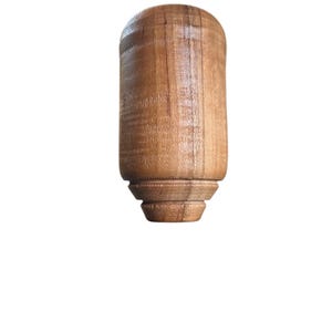 May include: A white ceramic mug with a black handle and the text "But First, Coffee" in a handwritten style. The mug is on a white surface. The mug is approximately 4 inches tall.