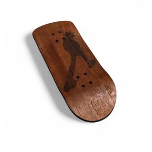 May include: A wooden fingerboard with a dark brown spur design. The fingerboard is made of wood and has a smooth finish. It features a black edge and several small holes for mounting. The spur design is a darker shade of brown.