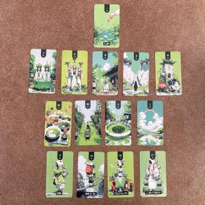 May include: A collection of fourteen rectangular tarot-style cards arranged in a grid, featuring green-toned illustrations of figures and landscapes. Each card displays a Roman numeral at the top and specific text at the bottom, including Flow, Finn, Aguadora, Teishumata, and Aquapartum.