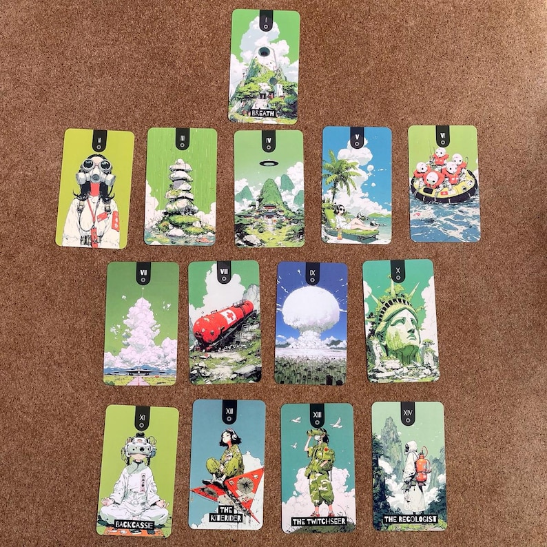May include: A collection of fourteen rectangular tarot-style cards arranged in a spread. Each card features distinct, colorful illustrations of figures, landscapes, and objects, with some cards displaying text labels like BREATH, BACKCASSIE, and THE RECOLOGIST.