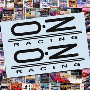 May include: A collage of car magazines with a light blue rectangle featuring the black text "OZ RACING" in a bold, stylized font. The background is filled with various car-related magazine covers.
