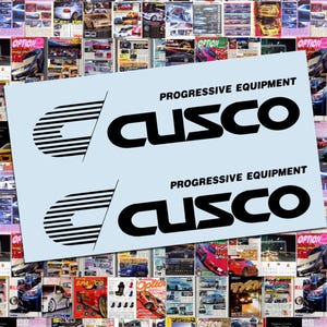 May include: A light blue sticker with the text "PROGRESSIVE EQUIPMENT CUSCO" in black. The sticker is placed over a collage of car magazines, featuring various car models and automotive content.
