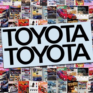 May include: A collage of car magazines with the word "TOYOTA" in large black letters on a light blue background. The magazines feature various car models and colorful designs, creating a busy, eye-catching display.