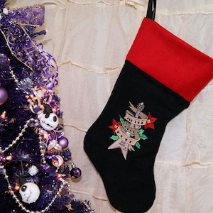 May include: Black and red Christmas stocking with an embroidered electric guitar and the text "Whole Lotta Rock" in a banner.