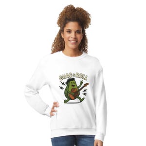 May include: White sweatshirt featuring a cartoon avocado playing a guitar with the text "GUAC & ROLL" above the avocado. The avocado has a black hairstyle and is surrounded by black lightning bolts.