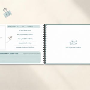 May include: A spiral-bound school memory book with light blue accents. The left page has space for a photo and prompts to fill in details like school name and favorite things. The right page has space for a class photo.