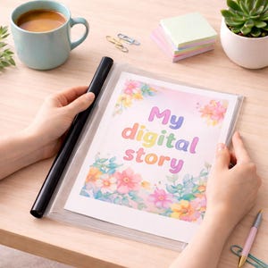 May include: A clear plastic document holder with a printed page that reads "My digital story" in rainbow colors. The page is decorated with watercolor floral designs. A black pen is held next to the document holder.