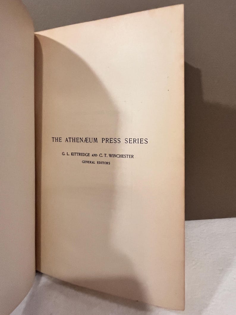 May include: Open book page with text: "THE ATHEN&AElig;UM PRESS SERIES" and the names "G. L. Kittredge and C. T. Winchester, General Editors." The page is off-white with a slight yellow hue, and the text is in a dark, classic font.