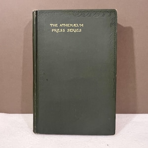 May include: A vintage book with a dark green cover. The title "THE ATHENAEUM PRESS SERIES" is printed in gold lettering. The book has decorative embossed detailing along the top and right edges.