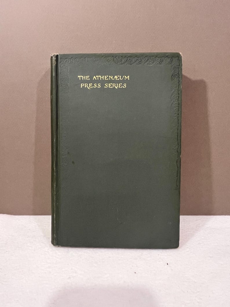 May include: A vintage book with a dark green cover. The title "THE ATHENAEUM PRESS SERIES" is printed in gold lettering. The book has decorative embossed detailing along the top and right edges.