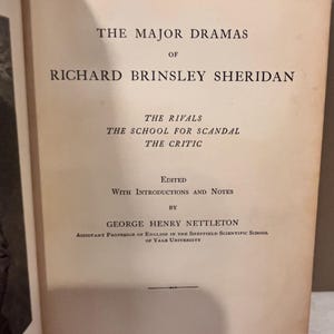 May include: Open book titled "THE MAJOR DRAMAS OF RICHARD BRINSLEY SHERIDAN" from the Athen&aelig;um Press Series. The book lists "THE RIVALS", "THE SCHOOL FOR SCANDAL", and "THE CRITIC". Edited by George Henry Nettleton, published by Ginn & Company.