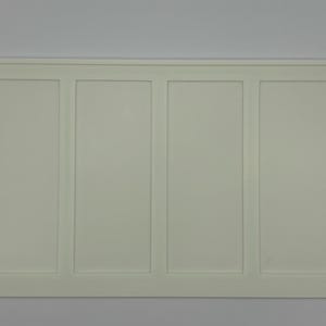 May include: A rectangular, off-white wall panel with four vertical sections. Each section is framed with a raised border, creating a clean, symmetrical design. The panel has a simple, modern aesthetic.
