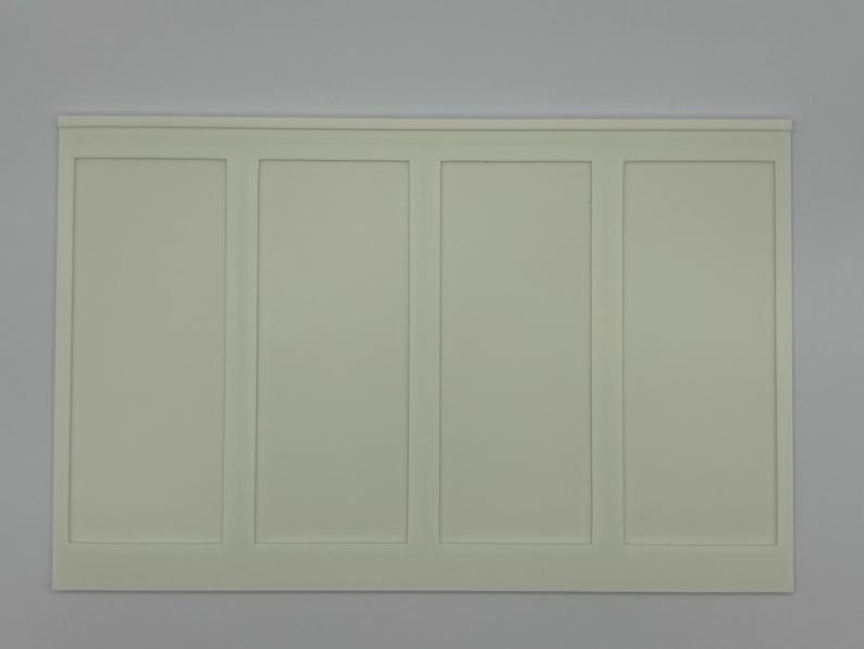 May include: A rectangular, off-white wall panel with four vertical sections. Each section is framed with a raised border, creating a clean, symmetrical design. The panel has a simple, modern aesthetic.