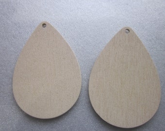 May include: Two unfinished wooden teardrop-shaped ornaments with a hole at the top for hanging.
