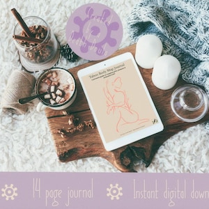 May include: A digital tablet displays a red line drawing of a person, with the text "Taboo Body Map Journal". The image includes a mug of hot chocolate, cinnamon sticks, and a decorative glass. The text "14 page journal" and "Instant digital download" are also visible.