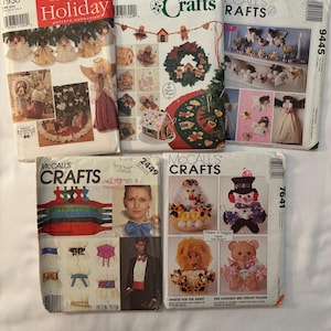 May include: A collection of vintage sewing patterns featuring holiday and craft themes. The patterns showcase designs for angels, Christmas decorations, and stuffed animals. The patterns are from Simplicity and McCall's.