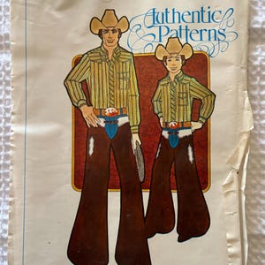 May include: A sewing pattern envelope titled Authentic Patterns 247 248 featuring an illustration of two figures wearing tan cowboy hats, striped long-sleeve shirts, and brown flared trousers with white fringe details and blue belt buckles.