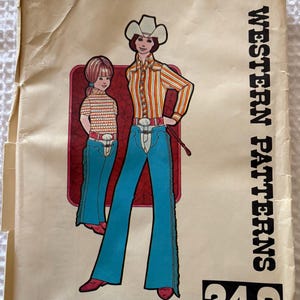 May include: An Authentic Patterns, Inc. sewing pattern envelope labeled Western Patterns 249. The illustration features two figures wearing cowboy hats, striped long-sleeve shirts, and blue flared pants with fringe detailing, set against a red background.