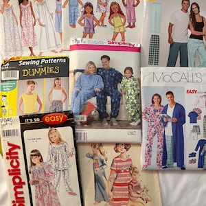 May include: A collection of sewing pattern envelopes featuring various designs for sleepwear and loungewear. The patterns include options for adults and children, with illustrations of the finished garments. Brands include Simplicity and McCall's.