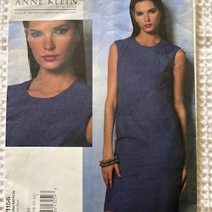 May include: An Anne Klein Vogue Patterns American Designer sewing pattern envelope, number V1156, size FF (16-18-20-22). The front features a blue sleeveless sheath dress with a round neckline, shown on a model in a full-length view and a close-up.