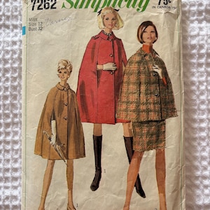May include: A vintage Simplicity 7262 sewing pattern envelope for a miss size 12, bust 32. The illustration features three capes: one tan, one red, and one plaid with a matching skirt. The text includes the pattern number 7262 and price 75c.