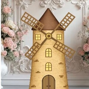 May include: A decorative windmill prop with a brown roof and blades, and a beige body with windows and a door. The prop is 6 feet by 4 feet. The background features white ornate wall paneling and pink roses.