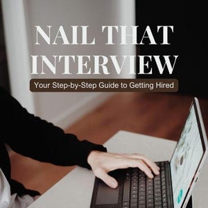 May include: A book cover with the title "NAIL THAT INTERVIEW" and the subtitle "Your Step-by-Step Guide to Getting Hired." A person is using a laptop. A small plant in a pink pot and a glass of water are on the table.