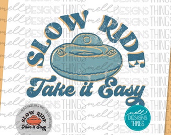 May include: A vintage-style graphic design with the text "Slow Ride Take it Easy" in blue and yellow. The graphic features a blue and yellow inner tube with a distressed look.