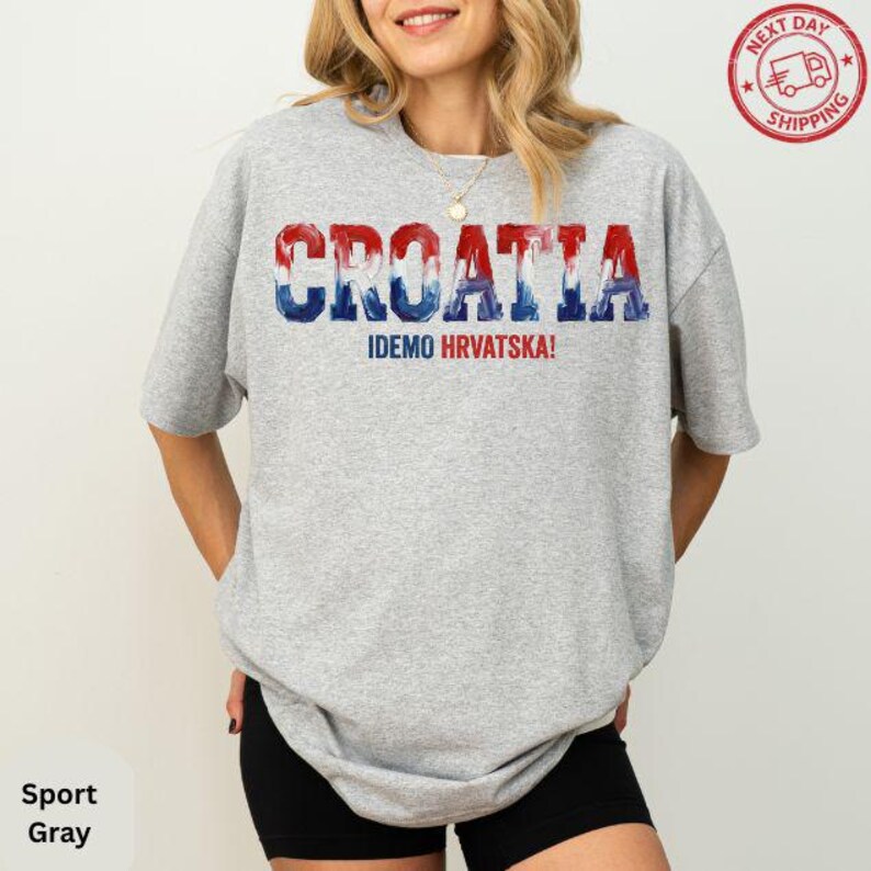 A woman wearing a grey t-shirt with the word "Croatia" printed on it.