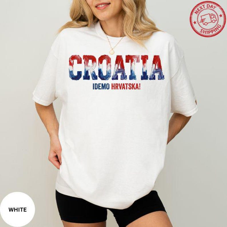 A woman wearing a white t-shirt with the text "Croatia" and "IDEO HRVTSKA!" printed on it.