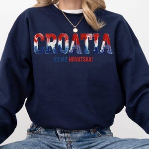 A navy blue sweatshirt with the word "Croatia" printed on it in a stylized font.