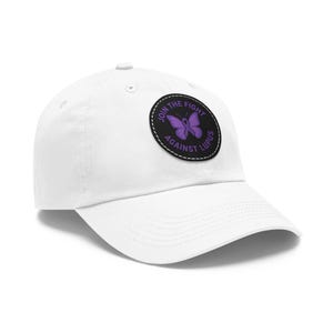 May include: White baseball cap with a curved brim. A circular patch on the front features a purple butterfly and the text "JOIN THE FIGHT AGAINST LUPUS" in white. The cap is made of a soft material and has a rounded crown.