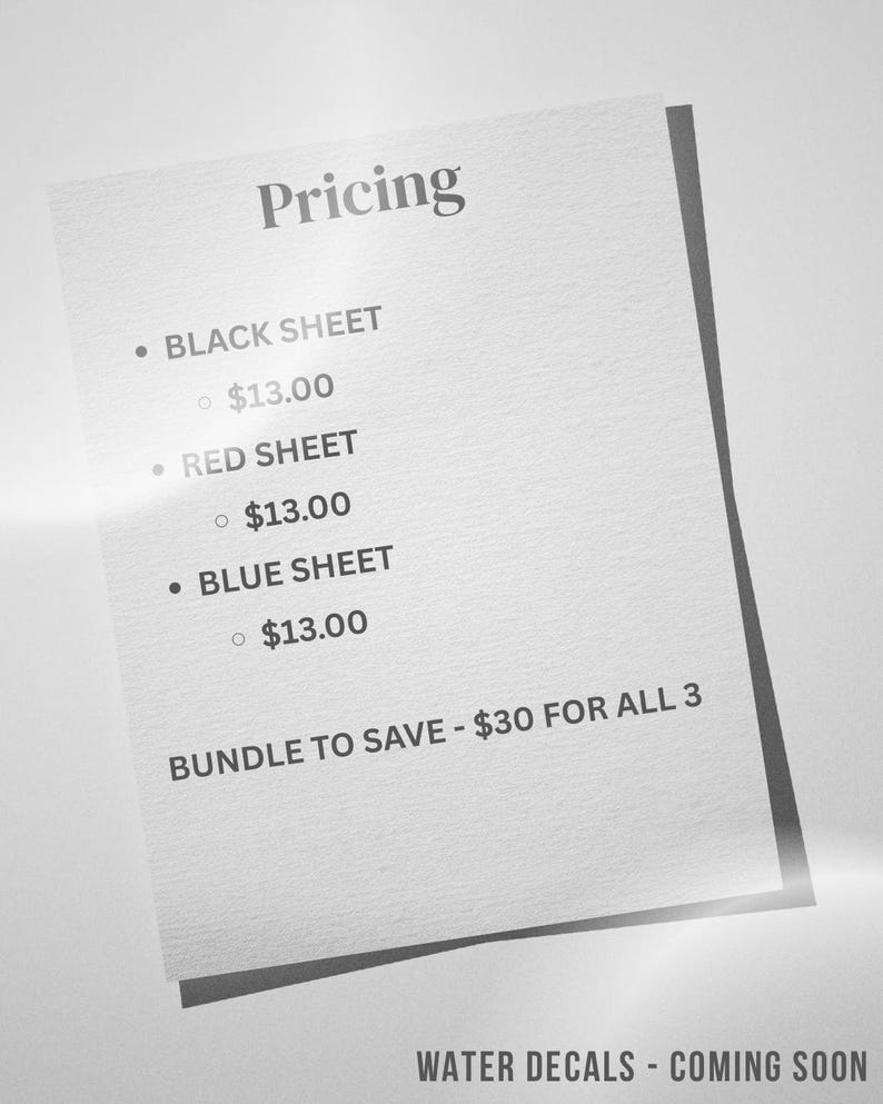May include: A white rectangular sign with dark text listing pricing for three items: Black Sheet, Red Sheet, and Blue Sheet. The text reads: Pricing, Black Sheet, Red Sheet, Blue Sheet, Bundle to save - $30 for all 3, and Water Decals - Coming Soon.