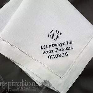 May include: White linen handkerchief with black embroidery. The embroidery includes the initials "D.L.S." in a diamond shape, the text "I'll always be your Peanut" and the date "07.09.16".