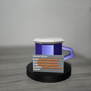 May include: A 3D-printed mug with a purple body, white top, and a handle. The mug sits on a black circular base. A small rectangular sign displays the text "Choose Option" and other options related to "Wizard's mind bomb."