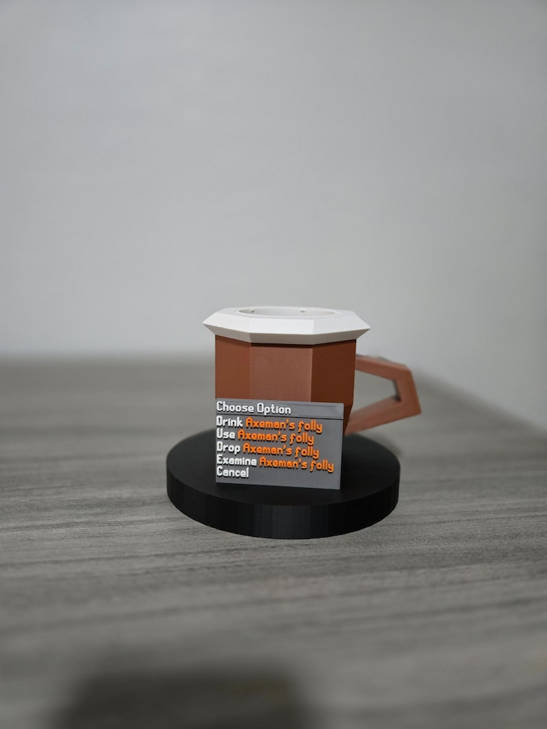 May include: A brown and white mug with a geometric design, featuring a handle and a black base. A small sign displays the text "Choose Option" and several options related to "Axeman's folly".