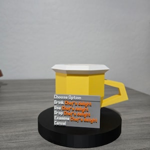 May include: A 3D-printed yellow mug with a white top and a rectangular handle. A small grey sign in front of the mug displays the text "Choose Option" and several options related to "Chef's delight."