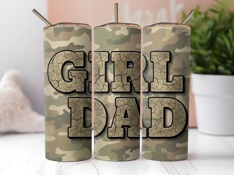 May include: A camouflage-patterned tumbler with the words "GIRL DAD" in a cracked, textured font. The tumbler has a silver straw and lid. The design is in shades of green, brown, and tan.