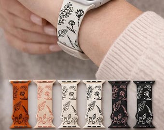 May include: A collection of six silicone watch bands featuring a black botanical line art pattern. The bands are available in orange, light pink, cream, white, yellow, black, and dark gray, with matching circular color swatches shown below.