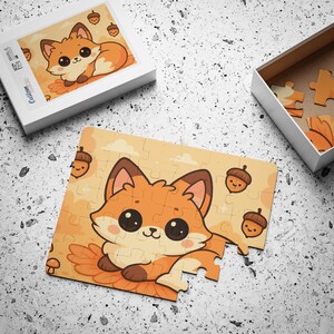 May include: A children's puzzle featuring a cartoon fox with large eyes, brown ears, and a fluffy tail. The puzzle pieces are orange and beige, with illustrations of acorns and a mushroom. The puzzle is in a white box.