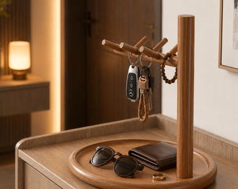 May include: A wooden valet tray featuring a vertical post with multiple pegs for hanging items. The circular base holds a pair of dark-framed sunglasses, a brown leather wallet, and a small ring. Keys are suspended from the wooden pegs.